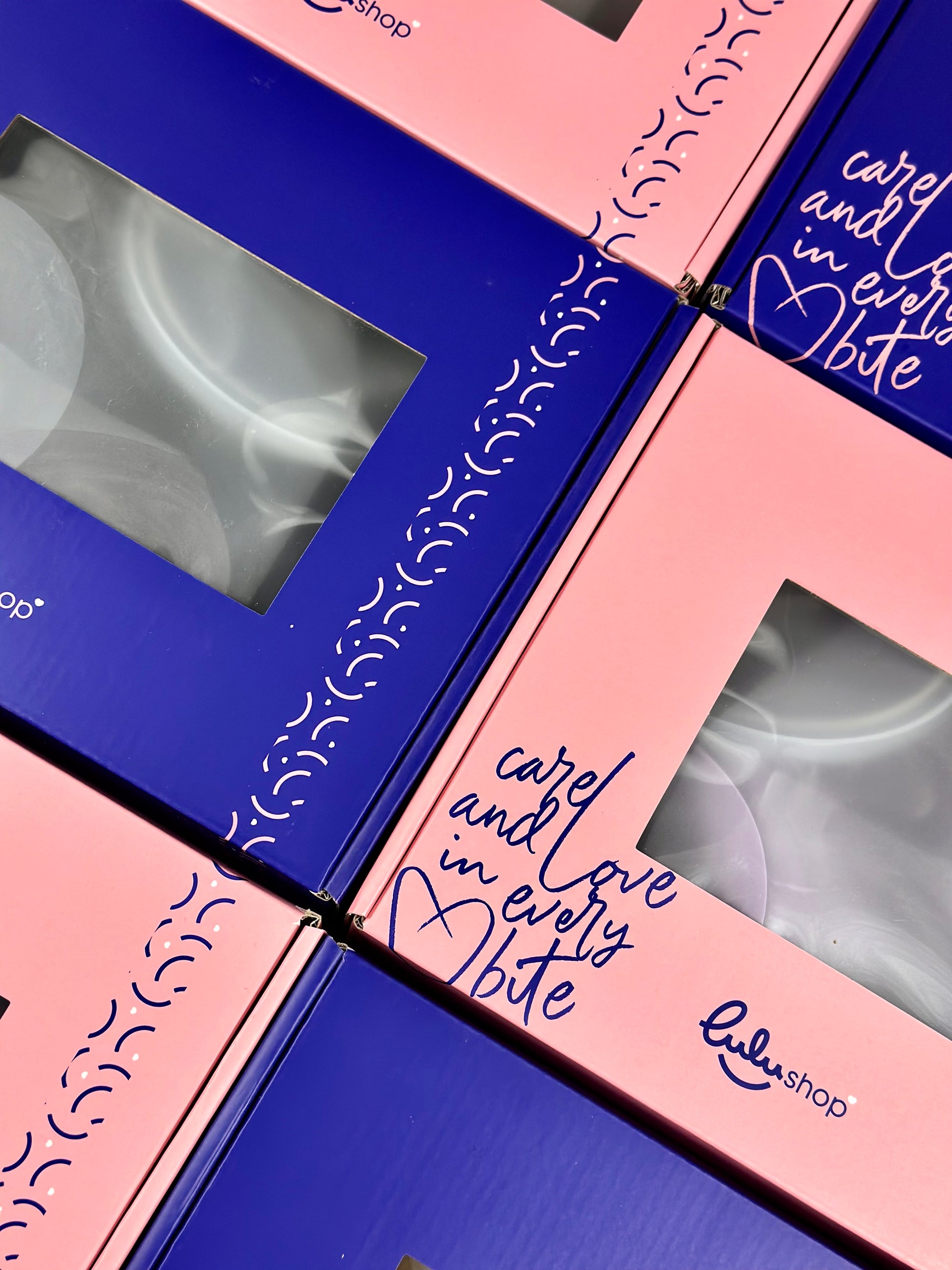 Lulushop baby feeding set packaging in pink and blue boxes with Care and Love in every bite branding