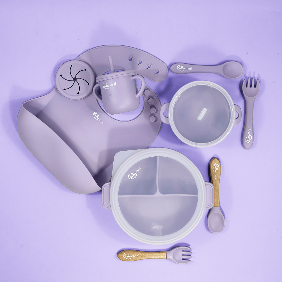 Lulushop 9-piece baby feeding set in Lavander Mist, featuring silicone suction plate, bowl, bib, cup, and utensils.