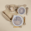 Lulushop 9-piece baby feeding set in Light Apricot, featuring silicone suction plate, bowl, bib, cup, and utensils.