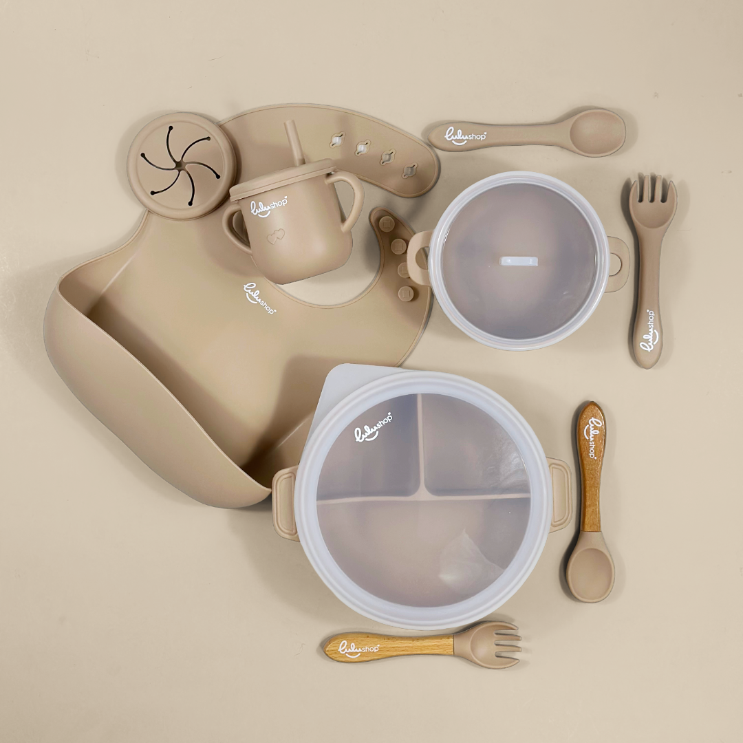 Lulushop 9-piece baby feeding set in Light Apricot, featuring silicone suction plate, bowl, bib, cup, and utensils.